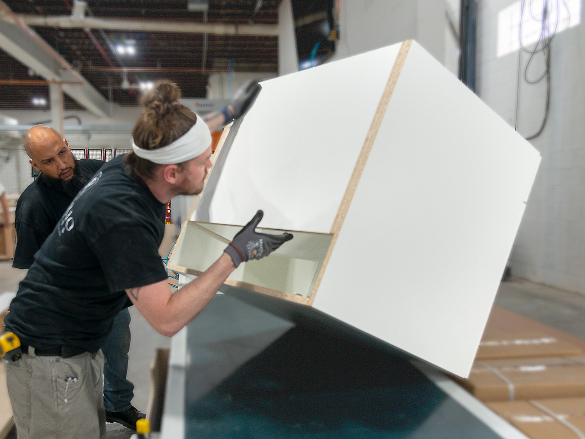 Rosario employee checking cabinet quality